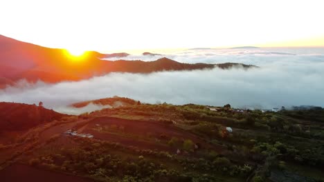 the clouds low in the valley, as the son rises it create a beautiful image, son breaking through the cloud, behind hills