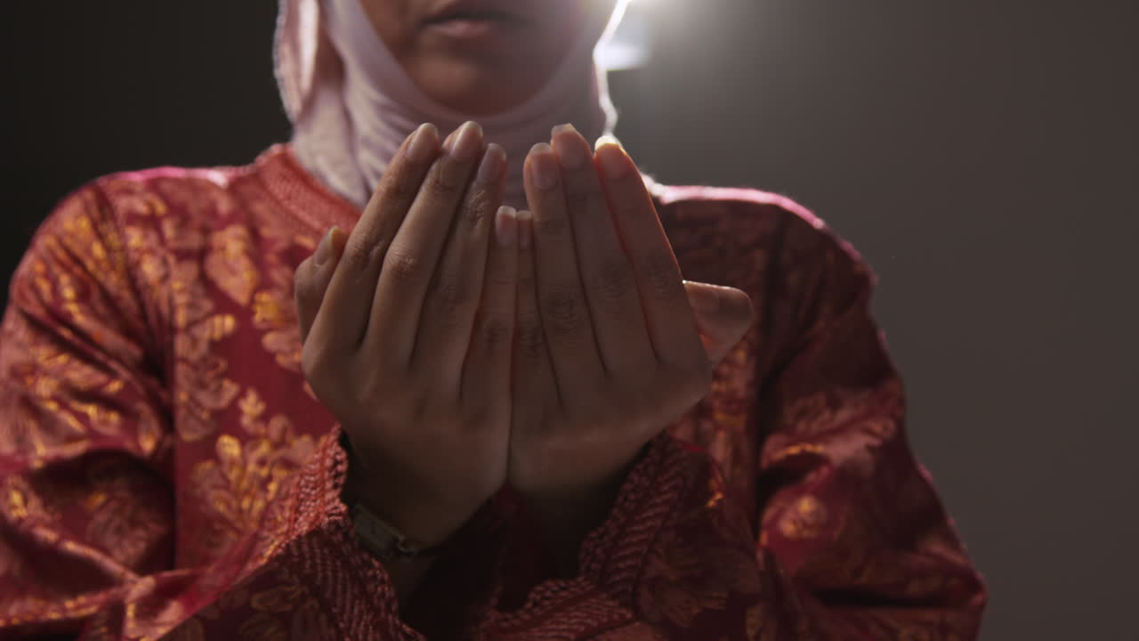 Close Up Studio Shot Showing Hands Of Muslim Woman Wearing Hijab Praying 3