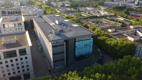 Blue-tramway-passing-along-modern-buildings-and-green-trees-on-a-boulevard