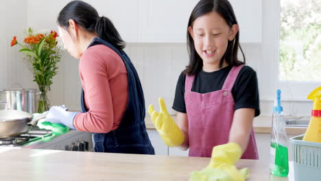 daughter and mother cleaning kitchen