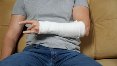 man shows rock sign with fingers of broken spoke bone