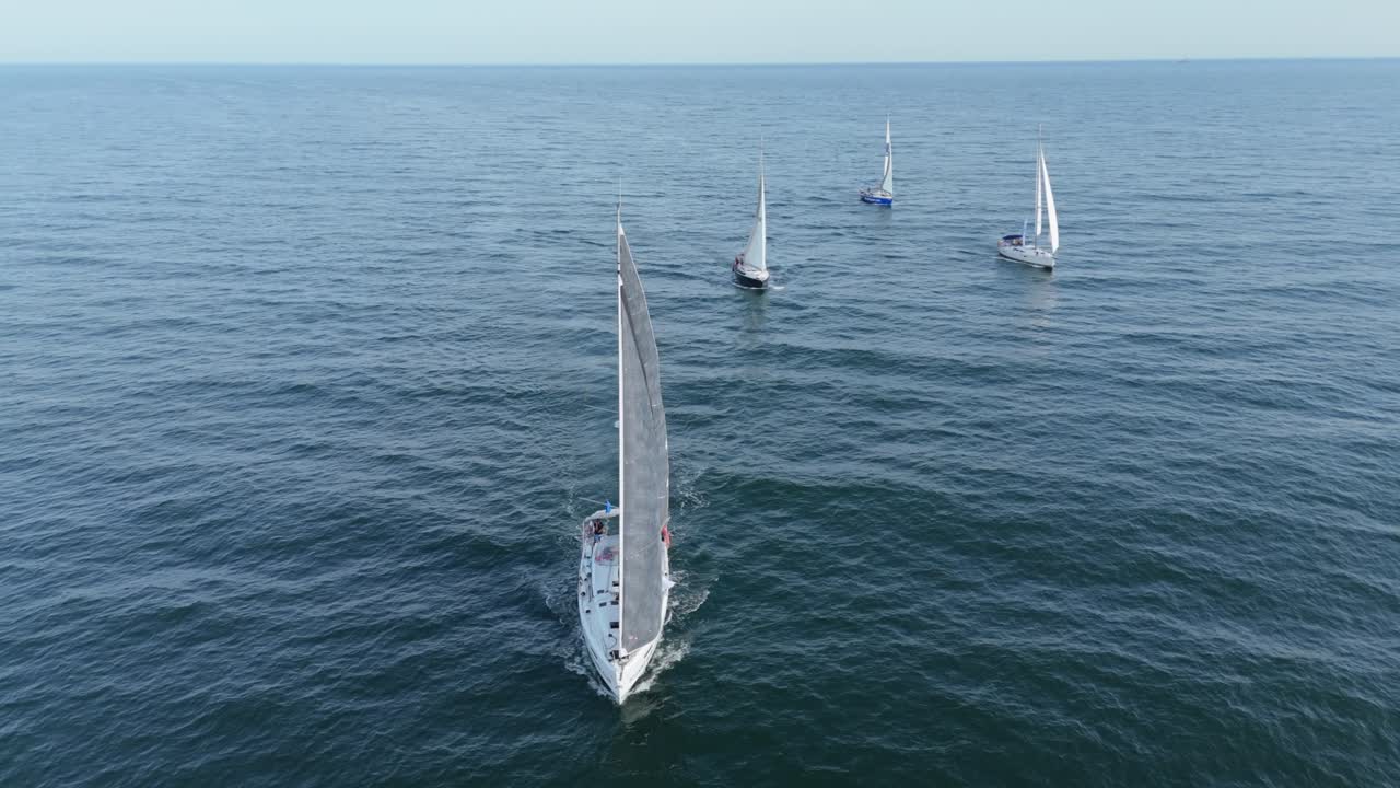 Sailboats racing on waves of calm Baltic Sea, exciting speed regatta aerial shot