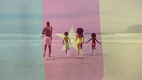 Running-into-ocean-waves,-family-enjoying-beach-with-cameroon-flag-animation