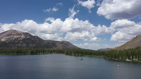 nature landscape with boats on the tranquil water of lake tahoe in california - aerial drone shot