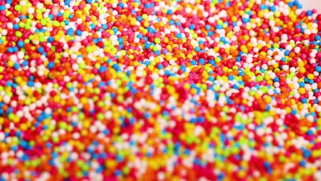 fingers interacting with vibrant candy sprinkles