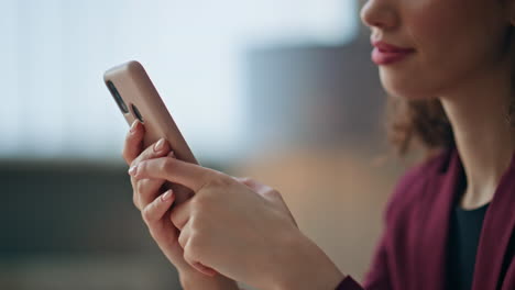 girl hands messaging mobile phone indoors closeup. businesswoman using cellphone