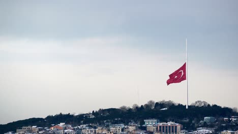 turkish flag over istanbul cityscape in winter