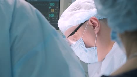 a surgeon in a sterile operating room performing a surgical procedure with focus and precision. represents healthcare, surgery, medical expertise, and patient care