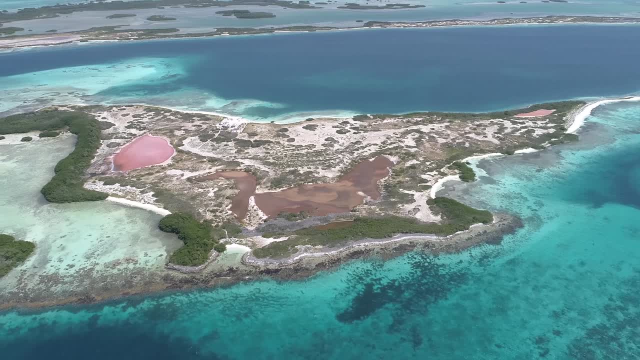 Moving-turn aerial view  beach cay  and-shallow-turquoise waters in the Caribbean sea in  agustin Los-roques National Park Venezuela.