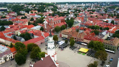 Drone-shot-of-Kaunas-Cathedral-Basilica-and-red-house-roofs-in-Kaunas-old-town-near-the-Nemunas-river,-in-Lithuania