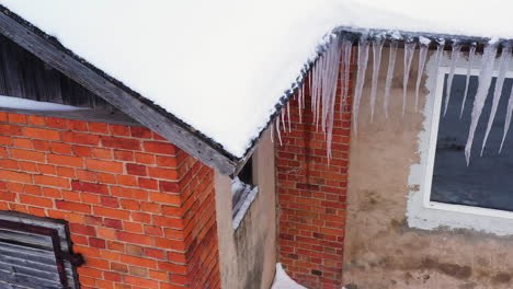 Eiszapfen-Hängen-Im-Winter-An-Der-Dachrinne-Eines-Backsteinhauses