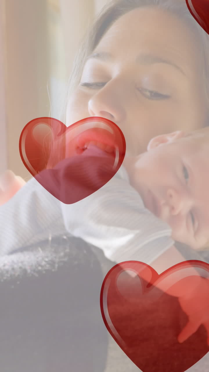 아기를 들고 있는 백인 여성 위에 떨어지는 마음의 애니메이션