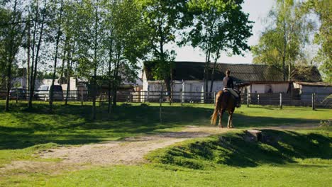 woman horseback riding in a rural setting