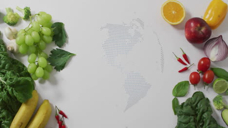 rotating globe animation over fresh fruits and vegetables on white background