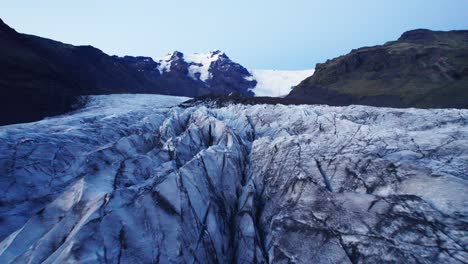 Aerial:-View-inside-Glacier's-serpentine-path-with-deep-crevasses-and-jagged-ice-formations,-evidence-of-the-climate-change-impact-on-the-constant-movement-and-transformation-of-this-natural-wonder