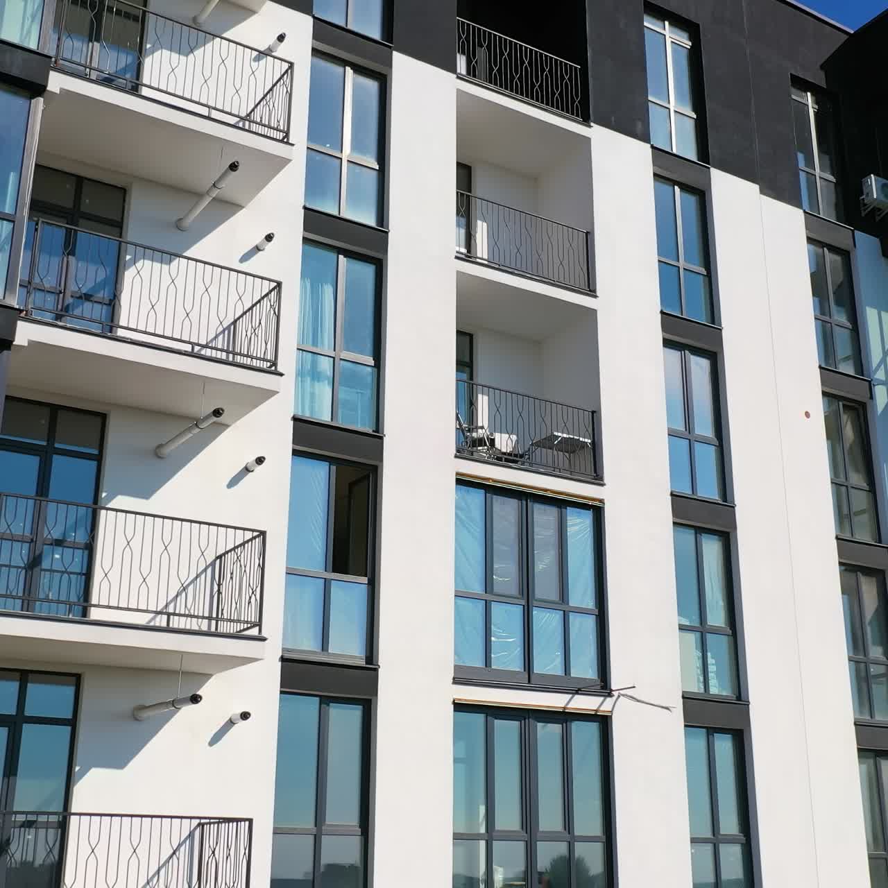 Newly built modern apartment building facade. Exterior of multi storey building. Modern design of urban architecture. Aerial view