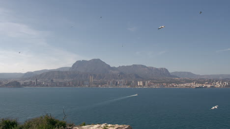 Coastal-town-with-mountain-and-ocean-landscape