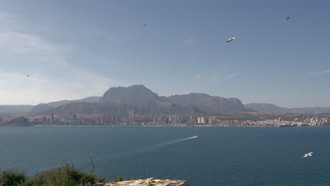 coastal town with mountain and ocean landscape