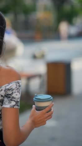 woman walking with coffee