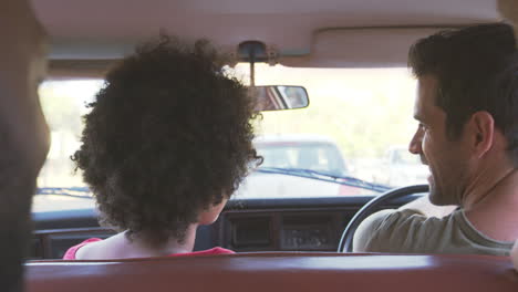 group of friends relaxing in car during road trip