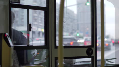 View-to-bus-cabin-with-female-driver-and-road-traffic