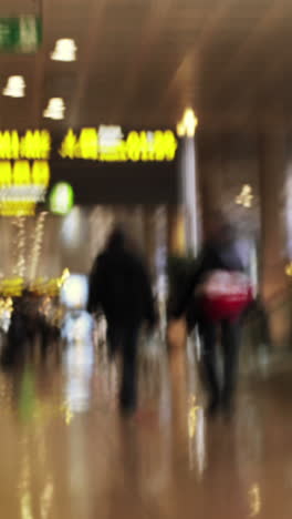 abstract rush around barcelona airport terminal in vertical