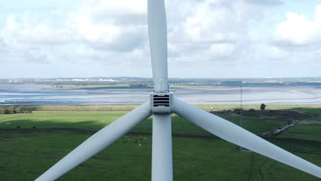 alternative green energy wind farm turbines spinning in frodsham cheshire fields aerial view closeup zoom out