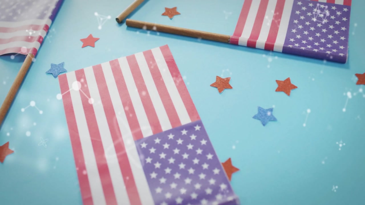 Upon sparkle activation, white particles drifting over US flags and stars adding festive glow
