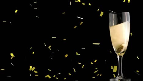 Animation-of-gold-confetti-falling-over-glass-of-champagne