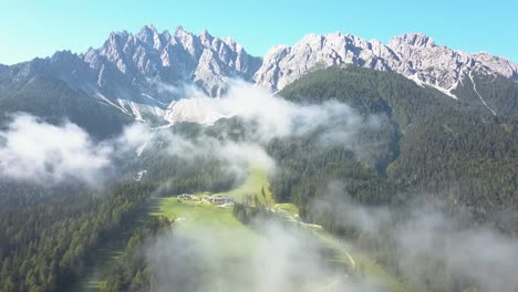 aerial over the clouds, a ski slope during summer taken from sporthotel tyrol in innichen, dolomite italy