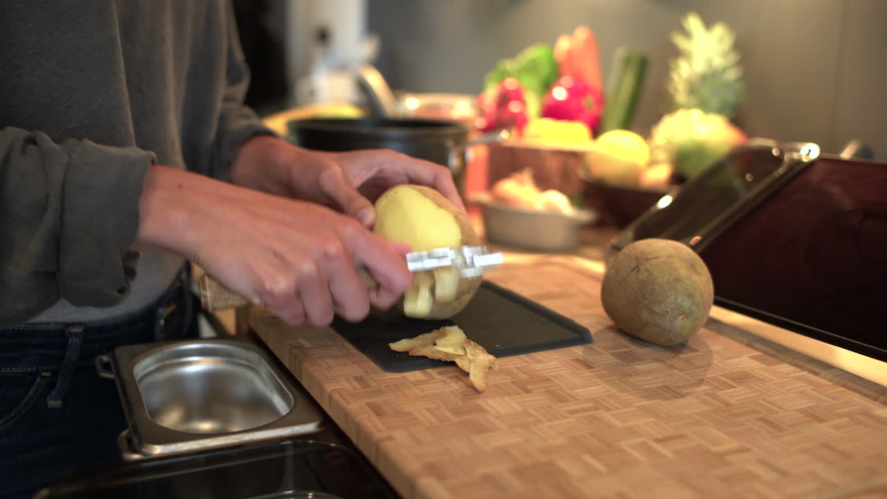 Dolly In Shot of Female Hands Peeling Potato
