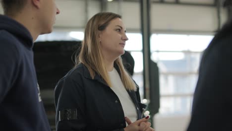 female manager discussing vehicle repair with mechanic in auto repair shop