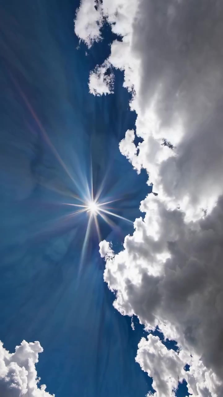Bright Sun Shining Through White Clouds with Crepuscular Rays