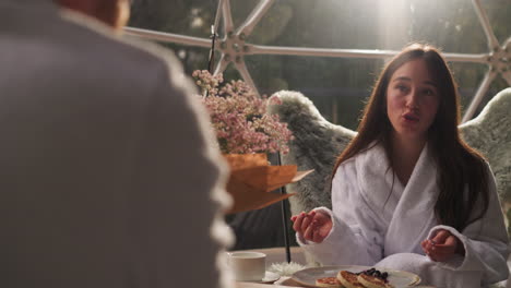 couple enjoys breakfast in a modern dome