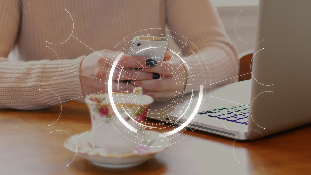 Man holding smartphone at wooden table, showing circular digital overlays for technology demos
