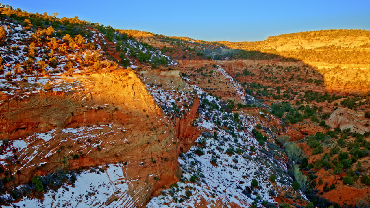 A drone flies high above the vibrant, sculpted red rocks near Page, Arizona.
