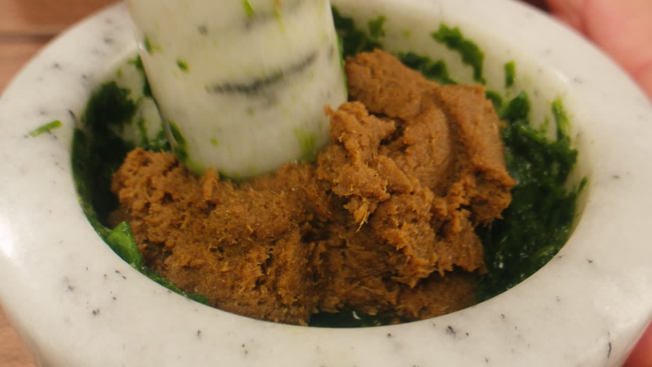 Making pesto with mortar and pestle
