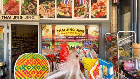 colorful storefront showcasing thai products and flags