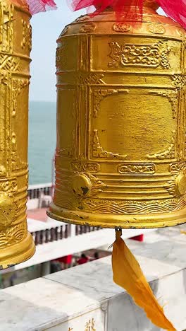 golden bells hanging in a vibrant temple