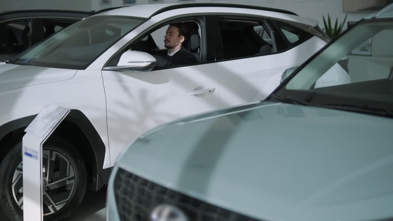 Man in a new car at a dealership