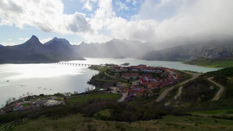 Slow-aerial-shot-of-the-village-of-Riaño-in-the-province-of-Castilla-y-Leon-in-Spain,-situated-on-a-water-reservoir-in-the-Cantabrian-mountain-range