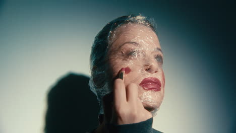 woman with plastic wrap on face