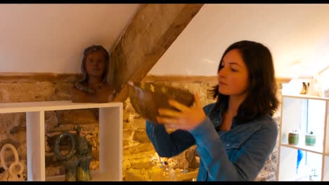 woman looking at earthenware bowl