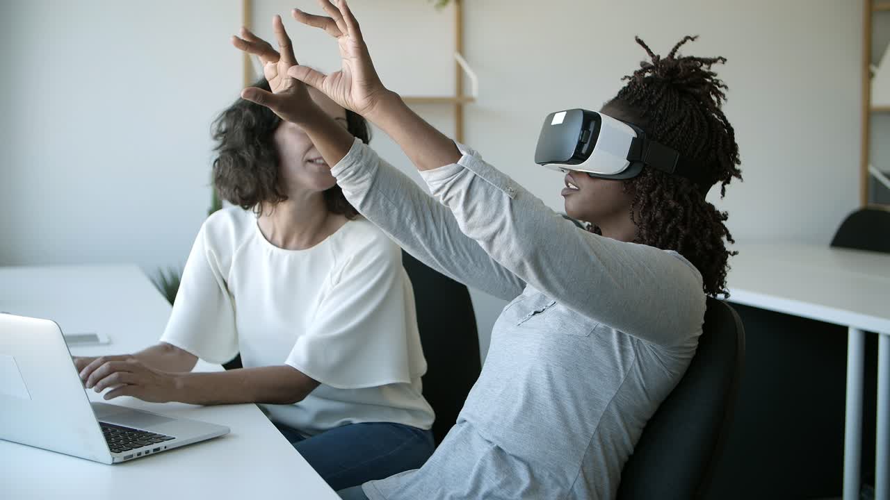 Slow motion shot of smiling women testing VR headset