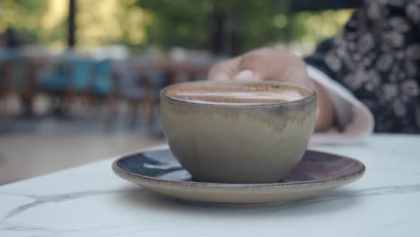 drinking coffee at an outdoor cafe