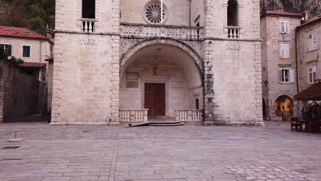 tilt upwards shot of cathedral of saint tryphon in kotor, montenegro with empty streets because of virus lockdown.