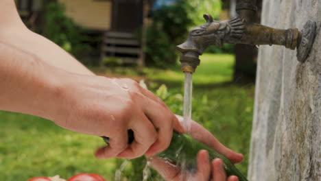 young man hand washing cucumber on running water, washing vegetables for salad