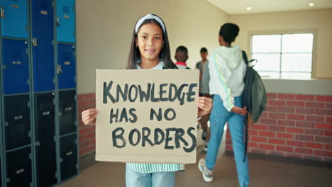 student holding a sign that says 'knowledge has no borders'