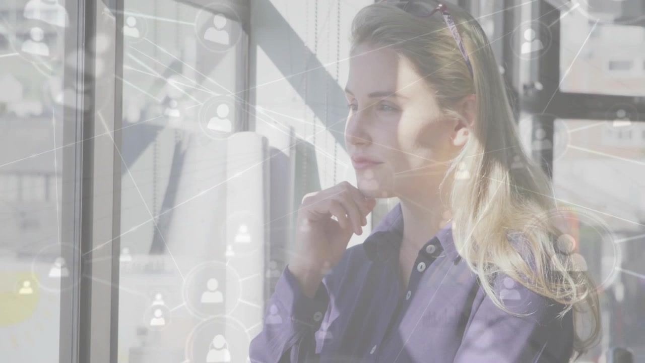 Office woman by window, raising hand to chin as network nodes intensifying, reflecting on tech