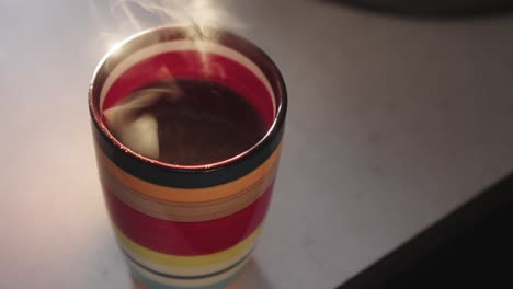 a colourful mug with morning coffee and a lingering aroma